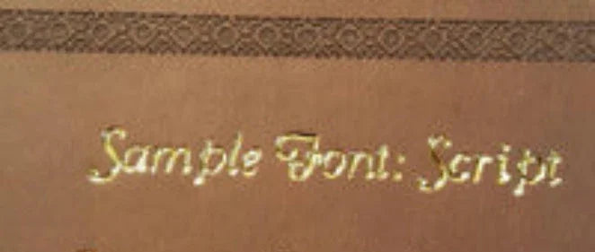 Gold script font sample engraved on brown background, DeMartineau handcrafted gift style