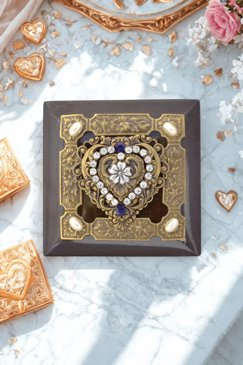 Handcrafted purple heart wood keepsake box with ornate jeweled heart design on marble surface