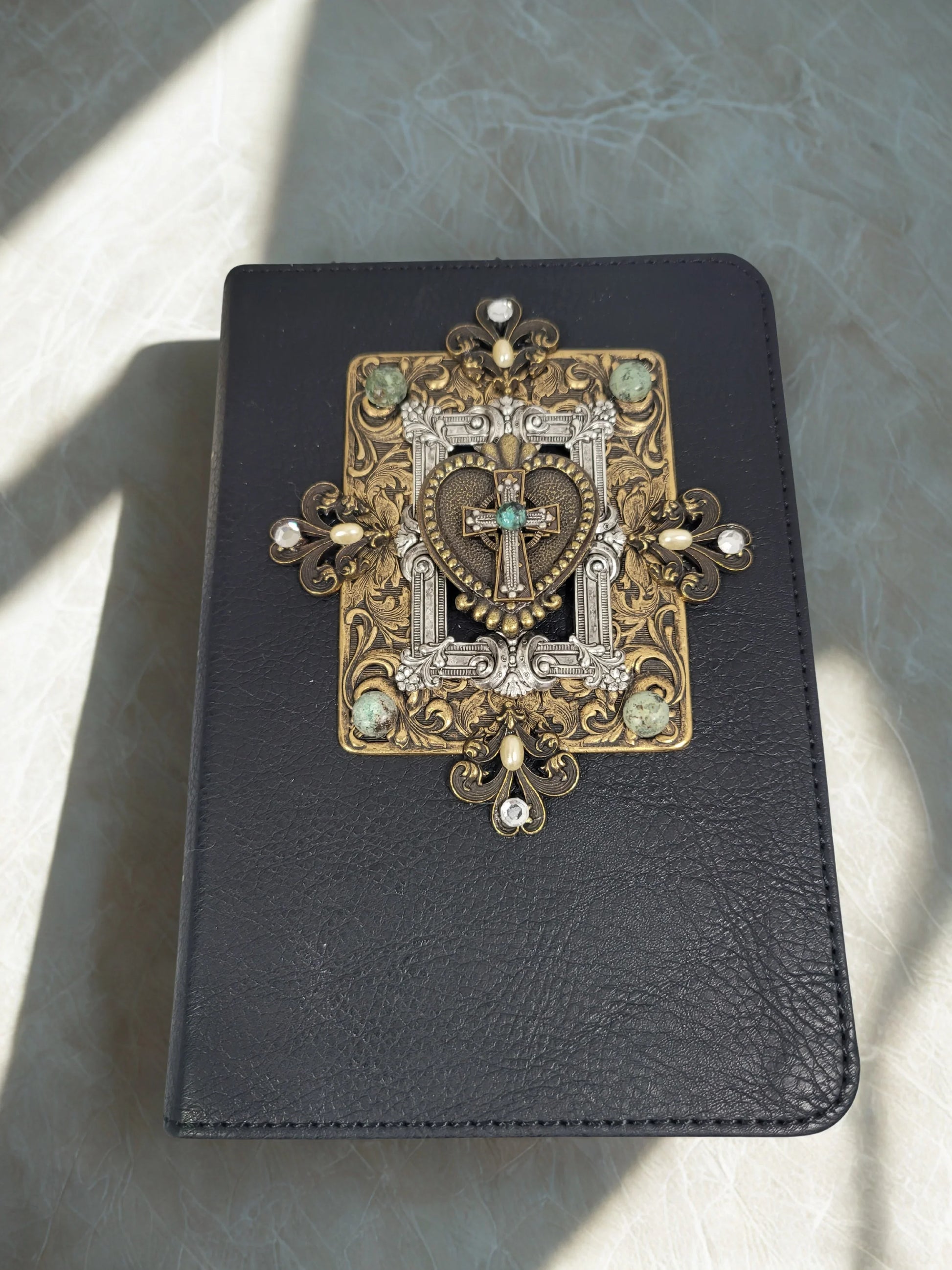 Handcrafted jeweled Bible with ornate gold and silver cross and heart embellishments