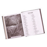 Open dark brown faux leather King James Bible showing printed text and detailed illustrations