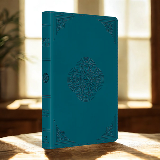 ESV thinline Bible leather teal with embossed design standing on wooden surface in natural light