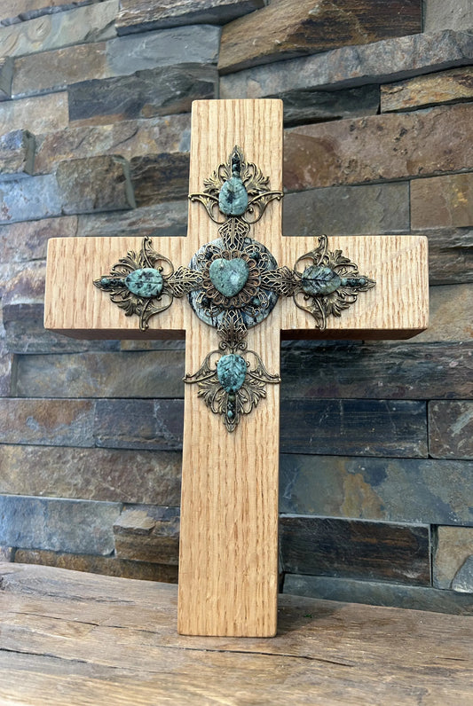 Dacole Designs handcrafted jeweled cross with turquoise stones on wooden wall cross background