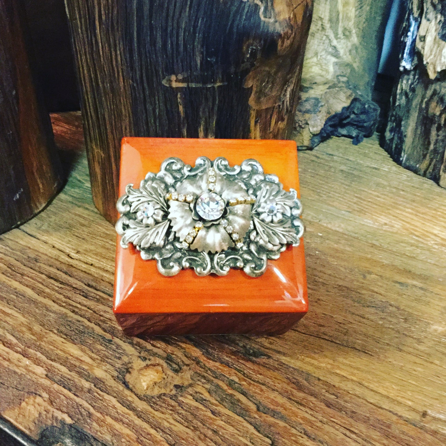 DeMartineau handcrafted wood ring box with ornate decorative metal clasp on wooden surface