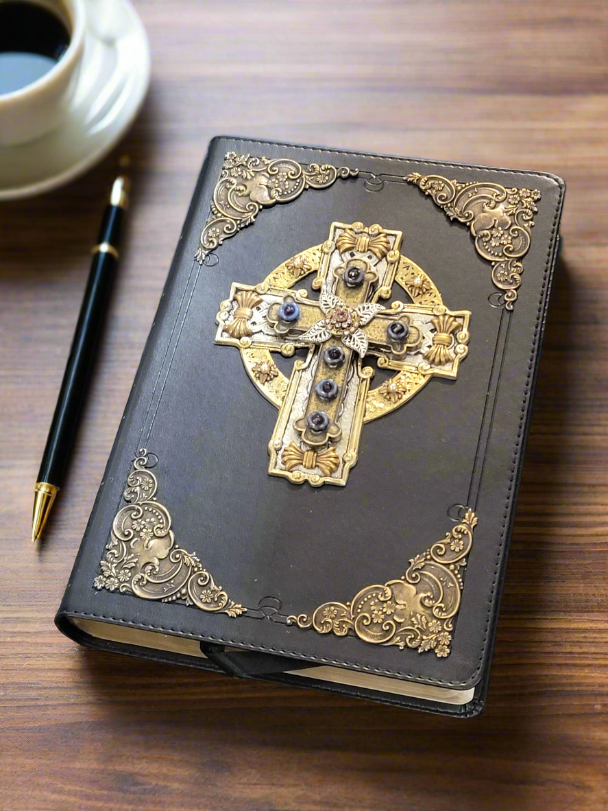 Jo Marz personal size jeweled celtic cross bible with ornate gold corner designs on wooden table