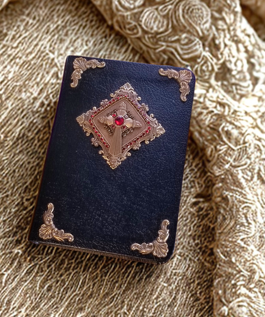 Compact size jeweled heirloom Bible by Jo Marz with black cover and ornate gold and red embellishments