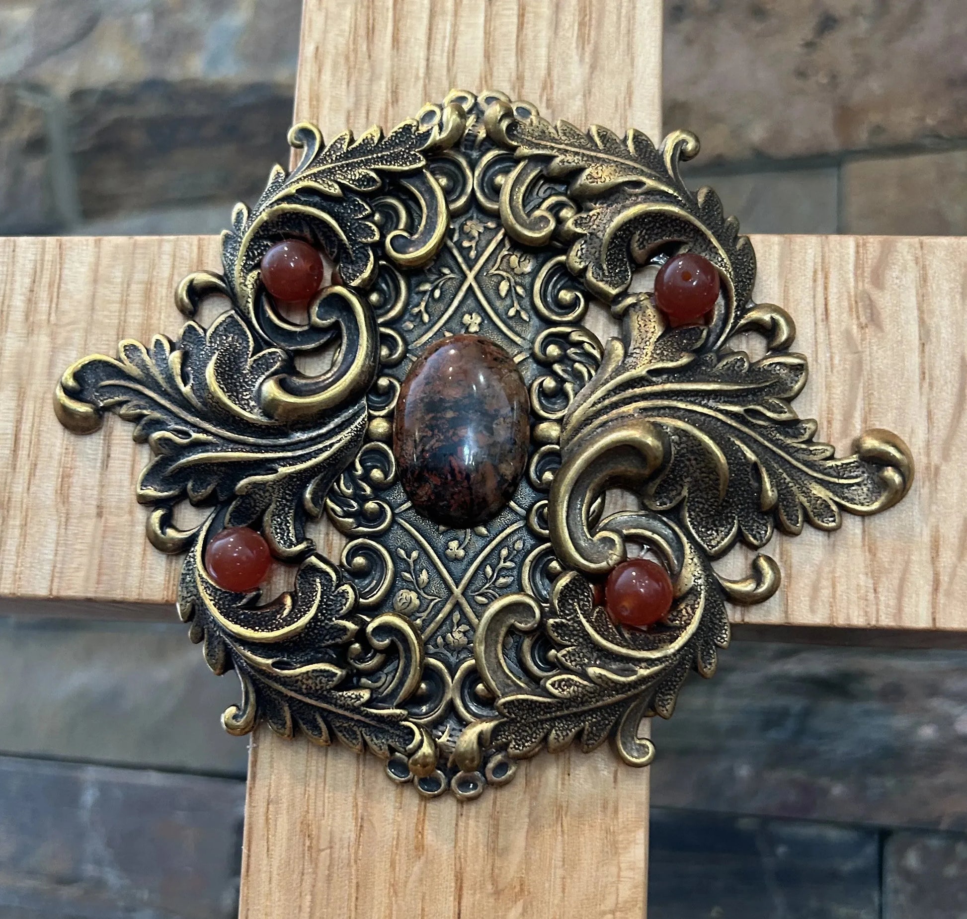 Jeweled oak cross for home decor with ornate antique gold floral metalwork and red gemstone accents