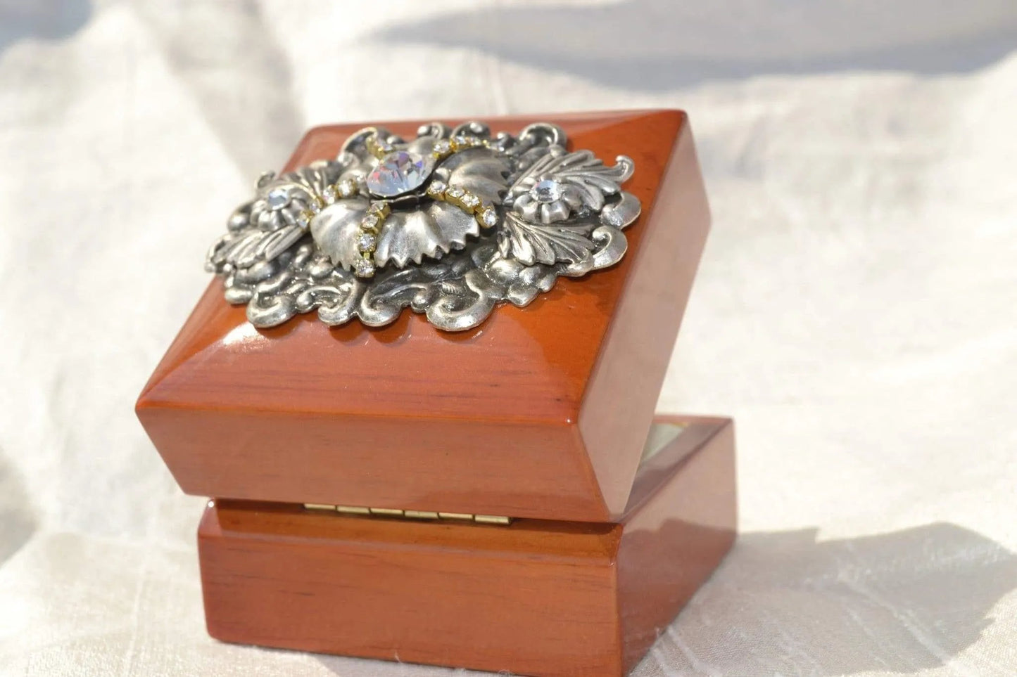 DeMartineau handcrafted wood ring box with decorative silver floral embellishment on top