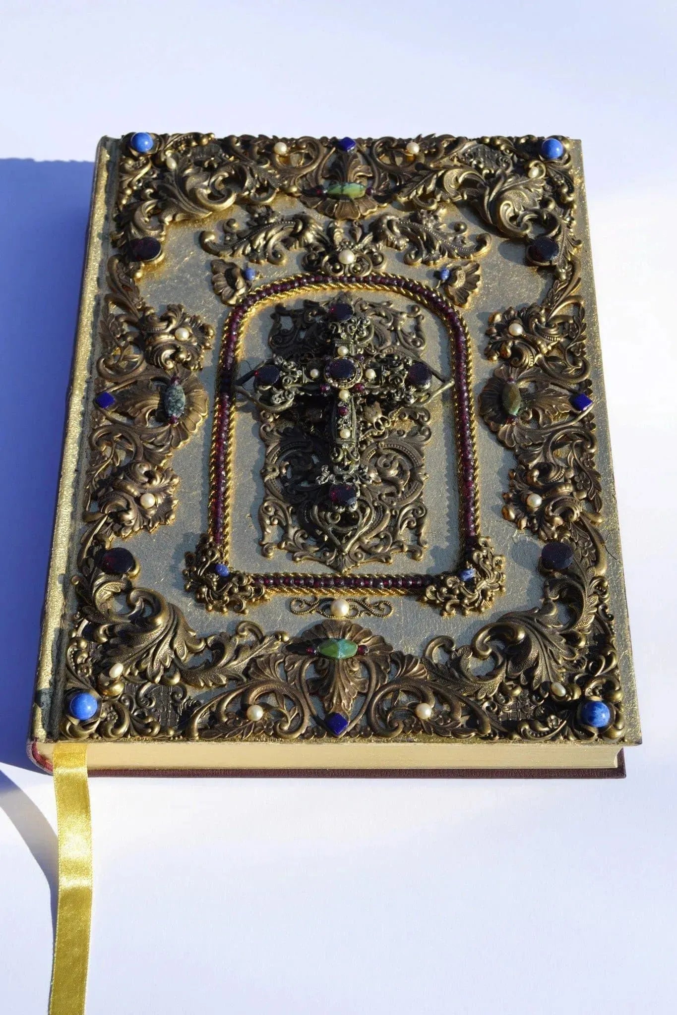 Jo Marz family size jeweled KJV Bible with garnets and pearls featuring ornate gold detailing and decorative cross