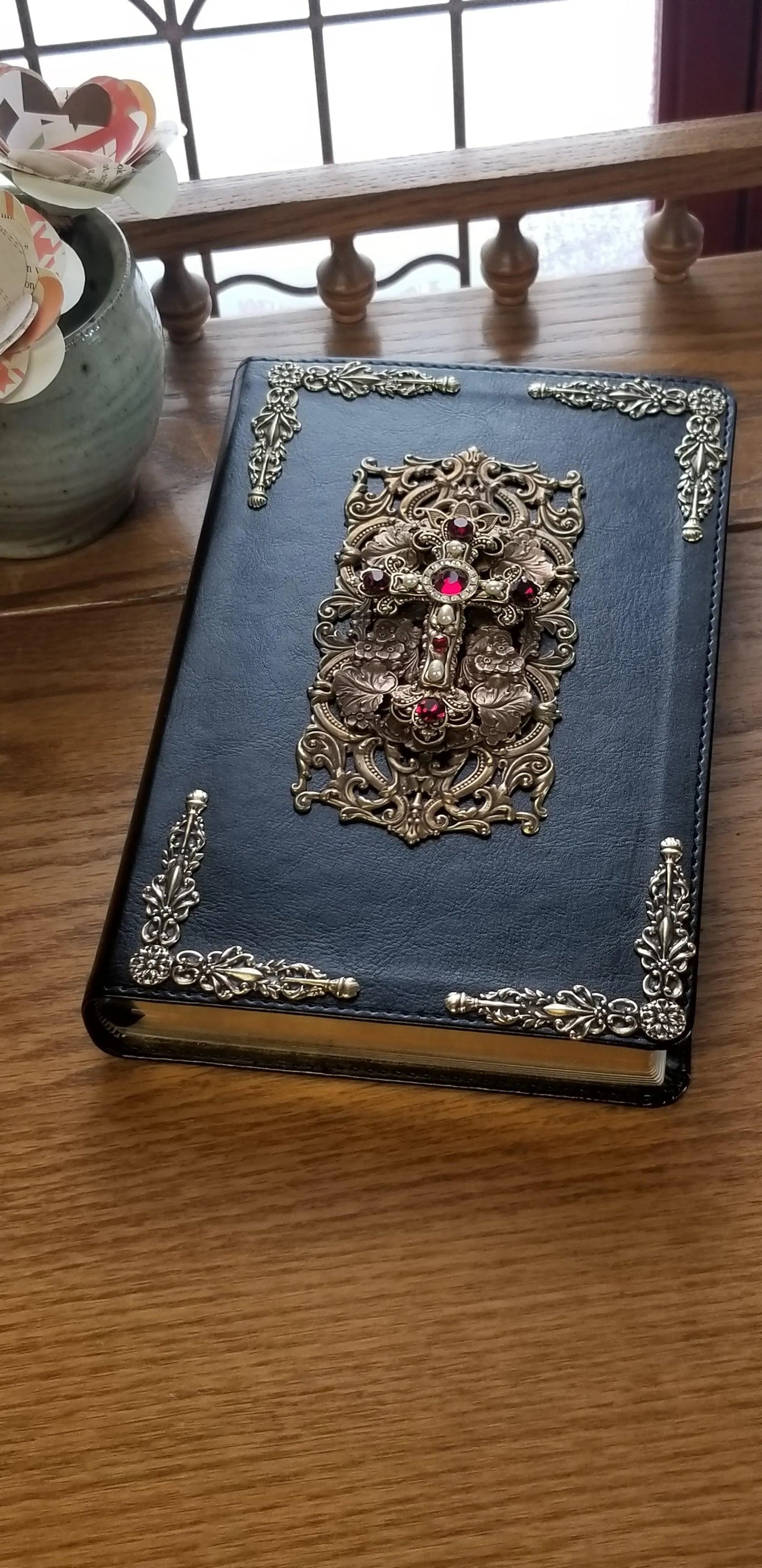 Jo Marz personal size Jeweled NKJV Bible with jeweled metal ornamental cover on wooden table