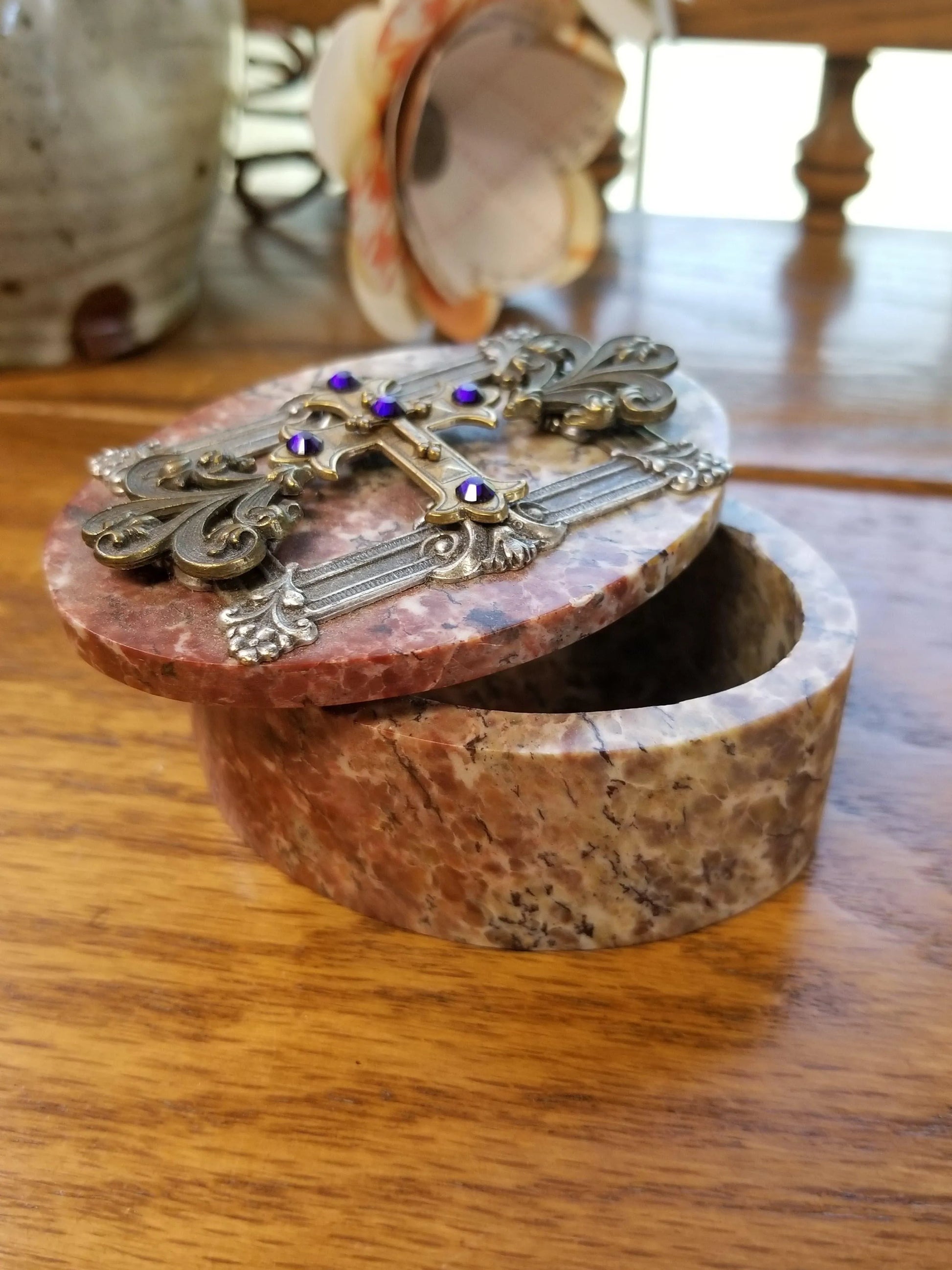Dacole Designs jeweled royal keepsake box with ornate cross and purple jewels on round marble lid