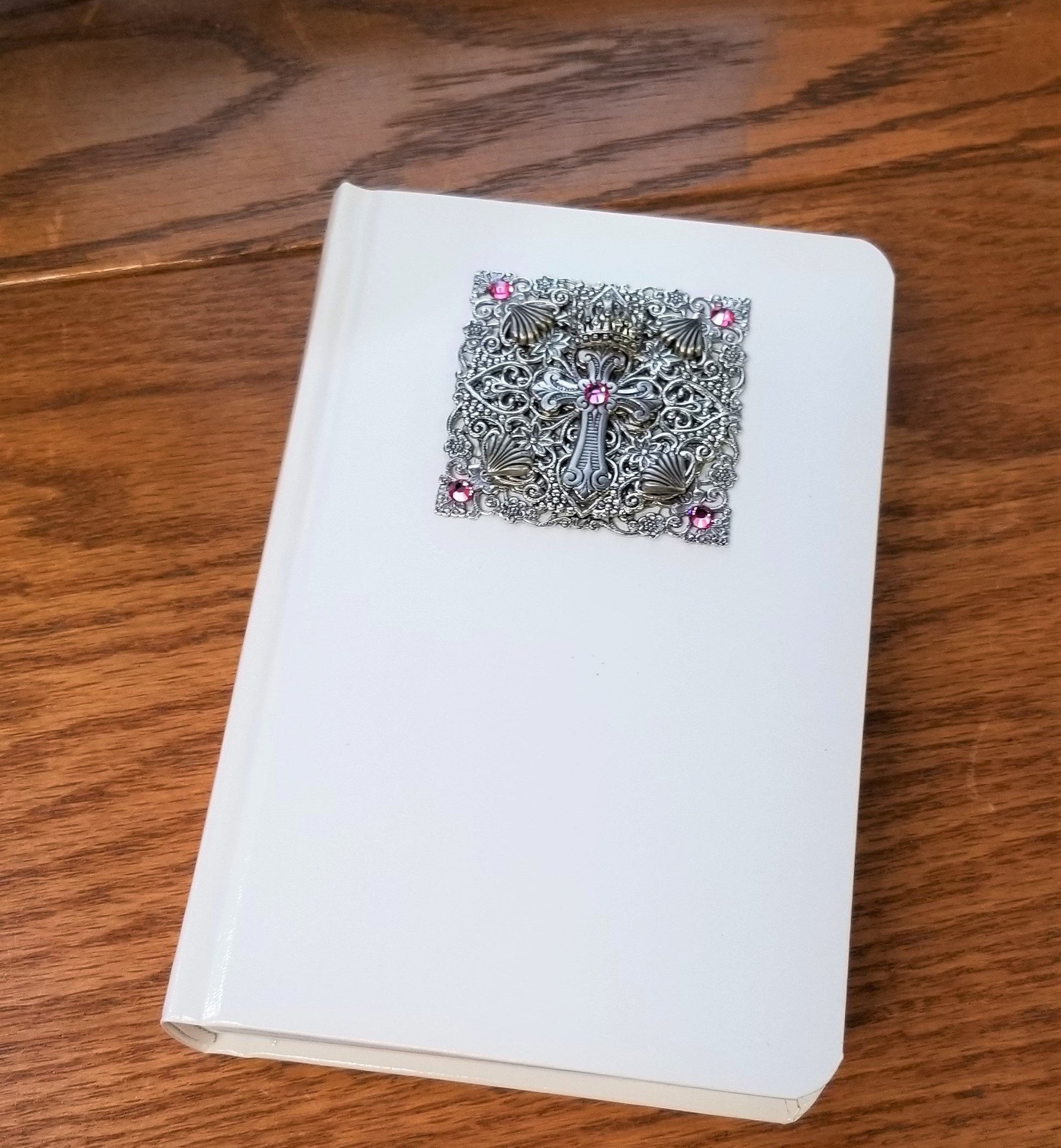 Compact size KJV jeweled baby Bible keepsake with ornate silver cross and pink jewels on white cover by Dacole Designs