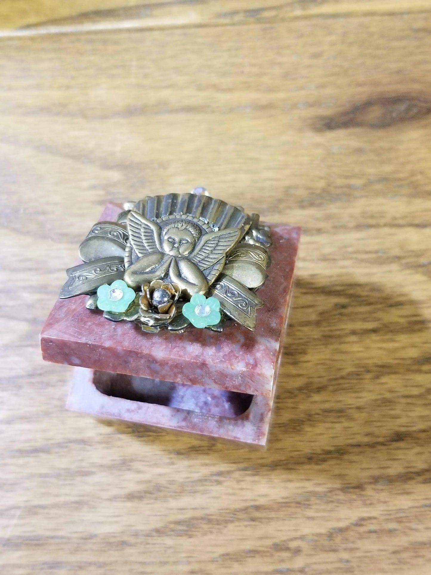Dacole Designs jeweled angel keepsake box with decorative angel and flower embellishments on a pink stone base