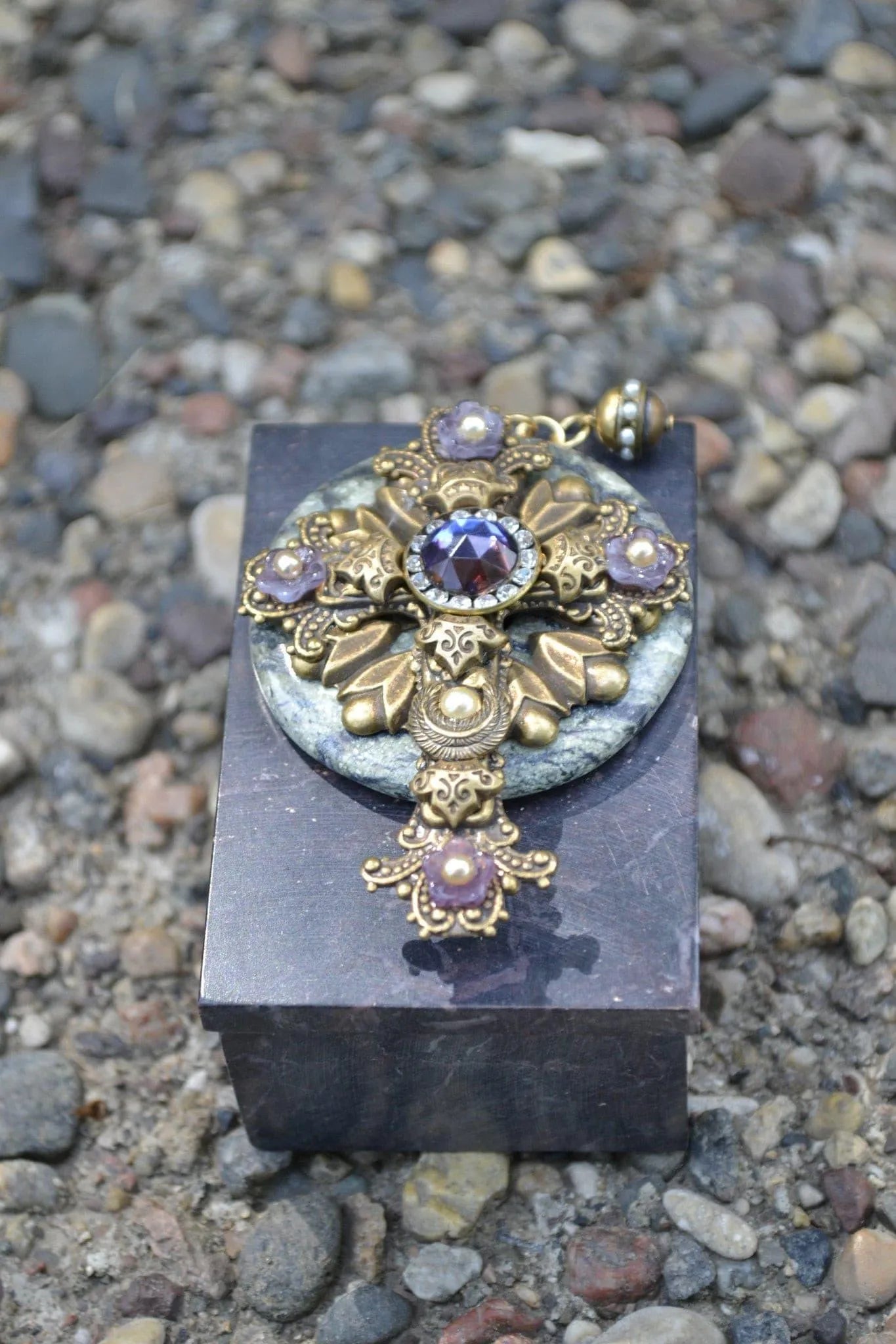Jo Marz jeweled cross soapstone box with ornate gold and purple gemstone decoration on textured black base